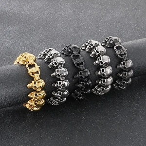 Detailed view of polished skull bracelets in gold silver black and gunmetal finishes