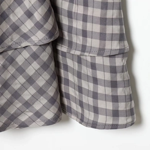 Plaid tiered mini dress featuring grey and white woven fabric with ruffle details