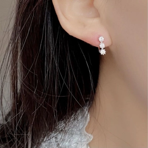 925 silver stud earrings featuring three vertical zircons shown on a female ear