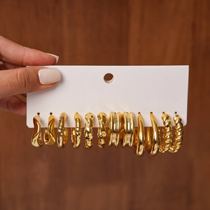 Detailed close-up of 12-piece set golden geometric textured metal hoop earrings set
