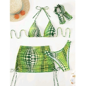 Detail of four-piece green and yellow polka dot swimsuit with skirt and headband