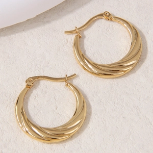 Minimalist golden stainless steel hoop earrings with spiral twist texture and buckle closure
