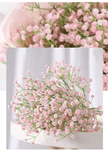 Close-up of pink artificial baby's breath flowers on a white tray for wedding decor