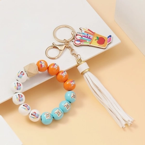 Detail view of Back to School beaded keychain with colorful wood beads and white tassel
