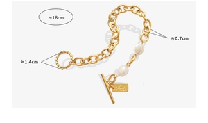 Detail of OT buckle gold bracelet with fresh water pearls and handmade tag