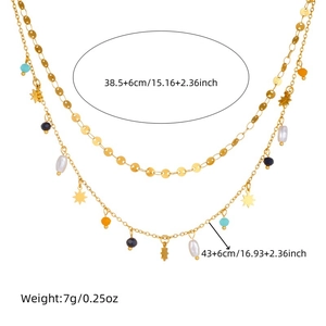 Gold double-layered necklace with star pendant, colorful beads and pearls on white backdrop