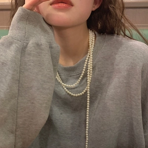 French vintage style multilayer pearl necklace shown on model in a casual setting