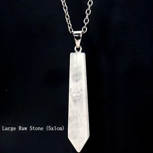 Macro detail of a large 5x1cm white crystal hexagonal point pendant with silver chain