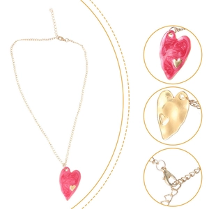 Detail view of pink enamel heart pendant on gold chain with lobster clasp and adjustable link