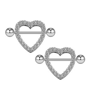 Macro shot of silver heart-shaped nipple rings with sparkling zircon stones