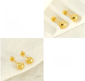 Detail of mirror-polished golden steel ball earrings showing high-gloss plating finish