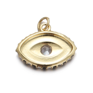 Macro shot of gold-plated evil eye pendant with clear zircon and scalloped edges