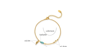 Detail of gold titanium steel anklet featuring turquoise beads and wing charms on white background