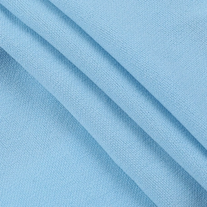 Macro view of light blue textured lace fabric showing soft knit detail and drape