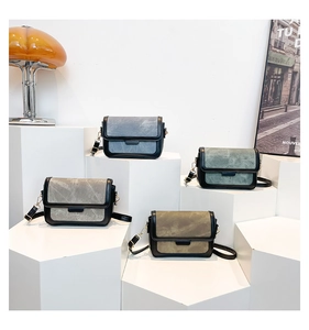 Group shot of vintage crossbody square bags in grey, blue, and olive green on stands