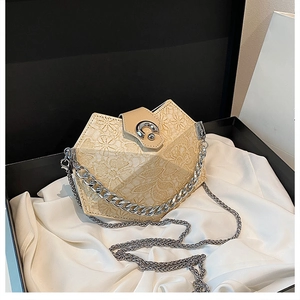 Detail of beige floral embossed handbag with silver chain strap in a black gift box