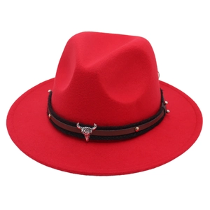 Detail view of red felt hat featuring a vintage silver steer head buckle and rivets