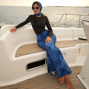 Detail of three-piece Muslim burkini set with leopard print and hijab on a boat