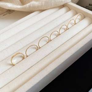 Detailed view of 7 pieces minimalist gold stackable rings set with smooth and twisted bands