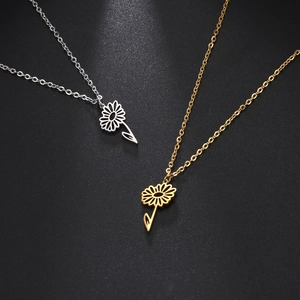 Elegant gold and silver stainless steel daisy flower pendant necklaces on black background