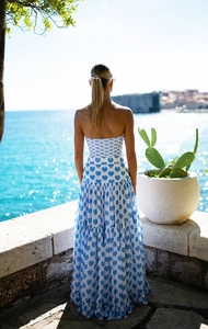Detail of tiered summer dress with heart print on a balcony overlooking the sea