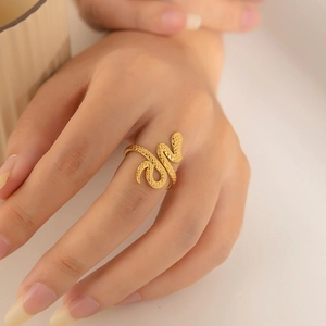 Irregular twisted 18K gold plated stainless steel snake ring worn on a finger