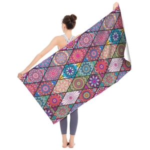 Microfiber beach towel with colorful bohemian mandala patterns held by a model