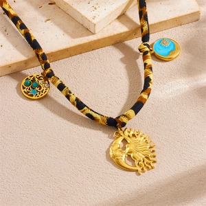 Leopard print cord necklace with sun moon pendants and blue enamel charms on stone base