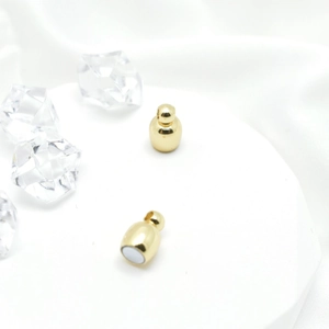 Minimalist gold magnetic clasps for necklaces and bracelets on white satin background