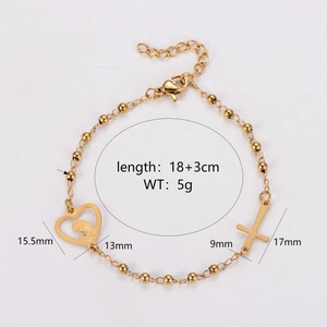 Gold stainless steel beaded bracelet featuring a heart and cross charm on white background