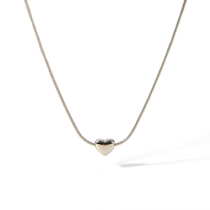 Polished silver heart pendant necklace with minimalist snake chain on white background