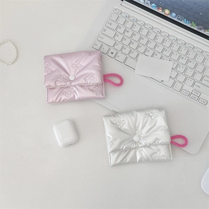 Detail of quilted bow texture storage pouch for cosmetics and small accessories