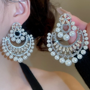 Dettaglio degli orecchini vintage a fiore con perle e cristalli con perni in argento