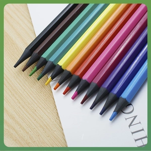 Set of 12 vibrant colored pencils with black hexagonal barrels on wooden desk