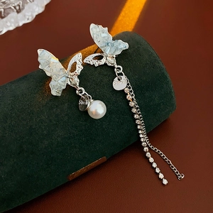 Detail of S925 silver butterfly earrings with blue crystals and rhinestone tassel