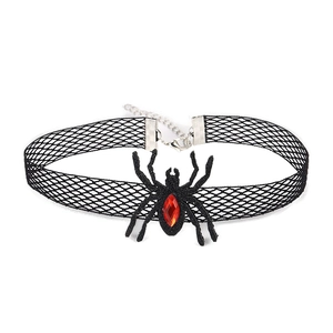 Detail of black spider lace choker with a central red gemstone and metal clasp