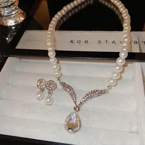 Elegant pearl and crystal drop jewelry set including necklace and earrings in a box