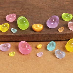 Detailed view of colorful luminous resin gold ingots in various sizes and vibrant finishes