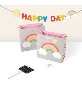 Detail of grey gift bag with cartoon cloud and rainbow patterns and pink dotted lining