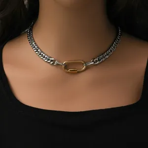 Polished two-tone stainless steel Cuban chain necklace with gold clasp on female model