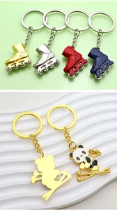 Detailed view of colorful winter sports ski and snowboard enamel keychains for gifting