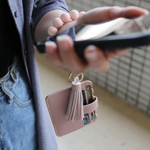 Pink faux leather card holder with multiple card slots and matching tassel detail