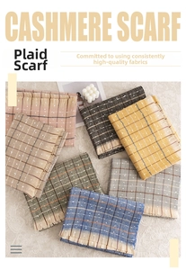 Detail of soft cashmere plaid scarf featuring colorful grid patterns and fringe edges