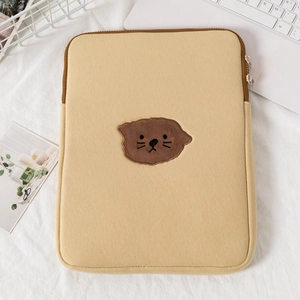 Detail of cute cat embroidery on beige protective padded laptop sleeve for 11-15 inch devices