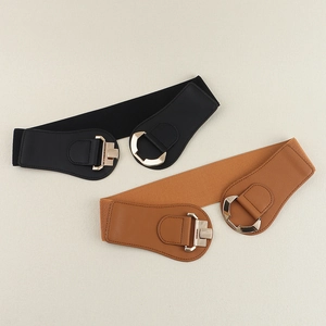 Close-up of black and brown elastic waist belts with gold geometric metal buckles