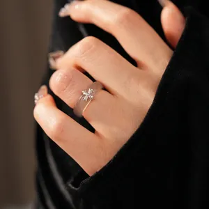 Minimalist chalcedony resin ring with silver cross element on a model hand