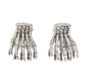 Detailed close-up of gothic silver skull hand hair clips with vintage metal texture