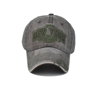 Close-up of vintage grey washed cotton baseball cap with green New York 1985 embroidery