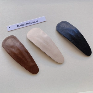 Three-piece set of waterdrop-shaped PU leather hair clips in dark brown, beige, and black