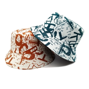 Double-sided graffiti bucket hats in orange and dark green canvas with letter print